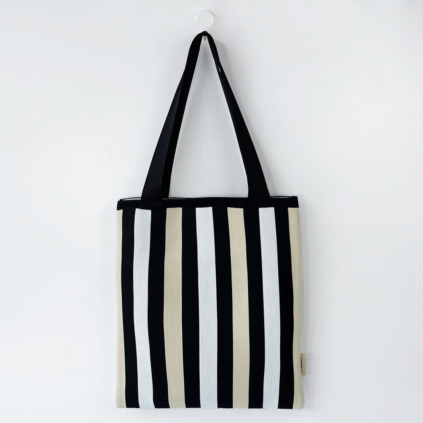 Front view of Chromatic Stripe Knitted Bag in black and white, ideal for errands and gifting.