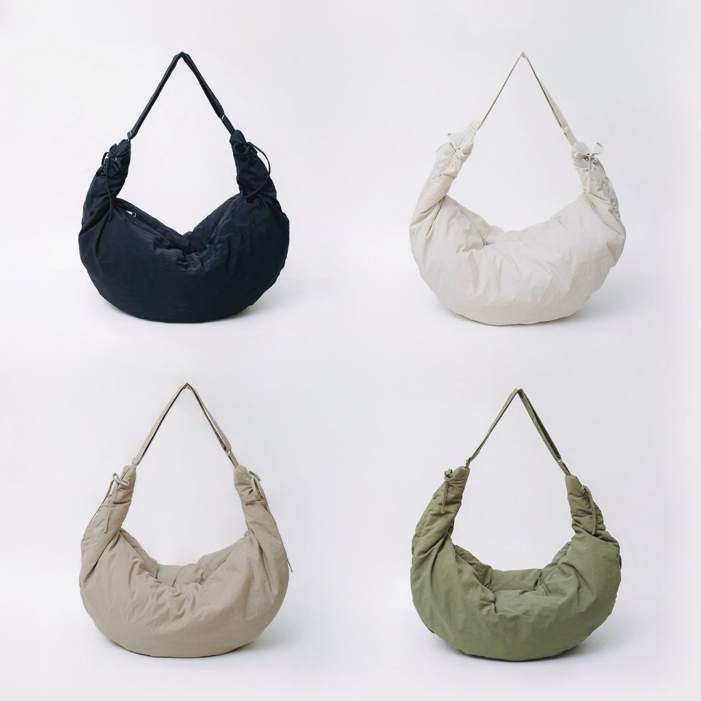 Group shot of the duvet crescent bag in black, off-white, khaki, and olive green.