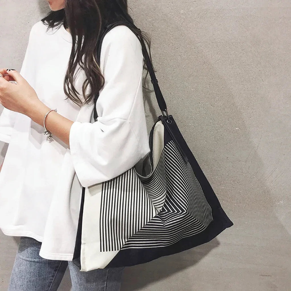 Mode wearing a maze print nylon tote on shoulder, showing a casual style.