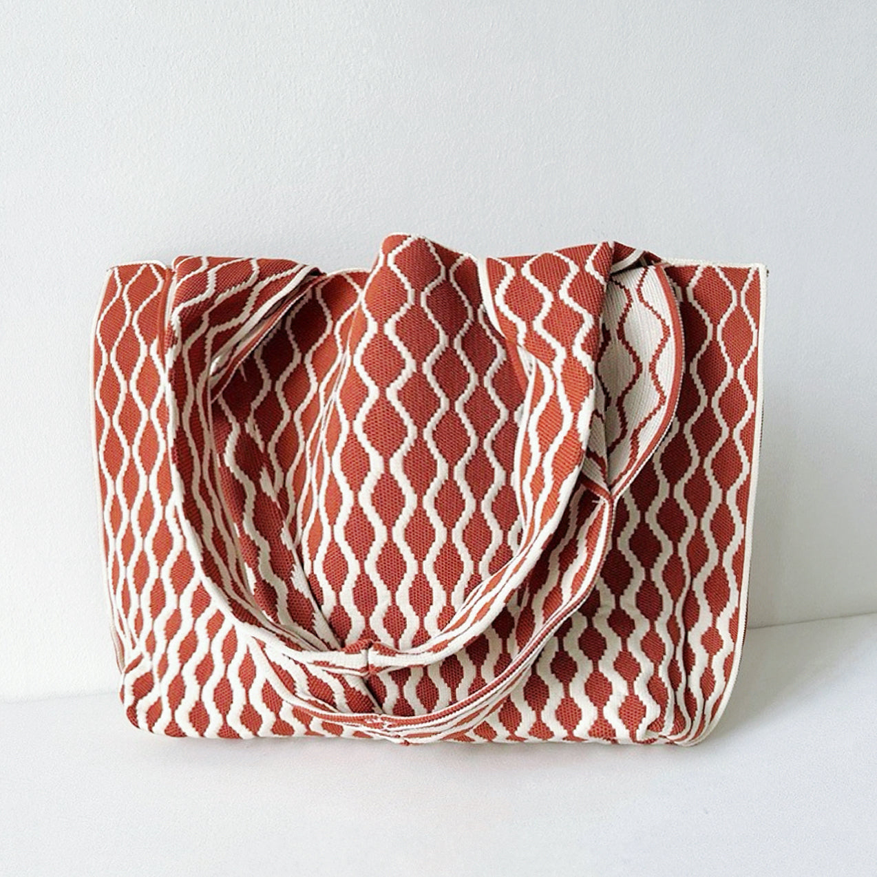 Close-up of Ripple Texture Tote Bag in rust red, ideal for errands and gifting.