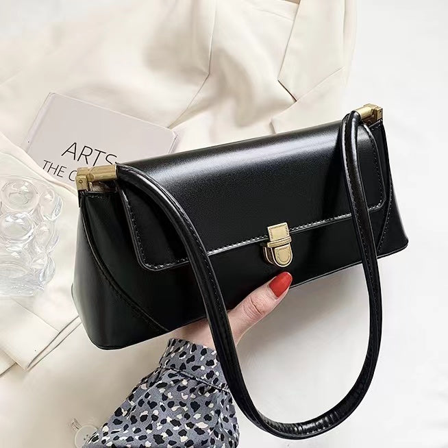 Model holding a black Vintage Baguette Bag in hand , ideal for city walks and gifting.