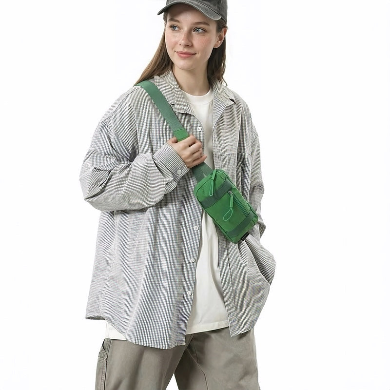 Model carrying the green mini belt bag as a shoulder crossbody accessory.