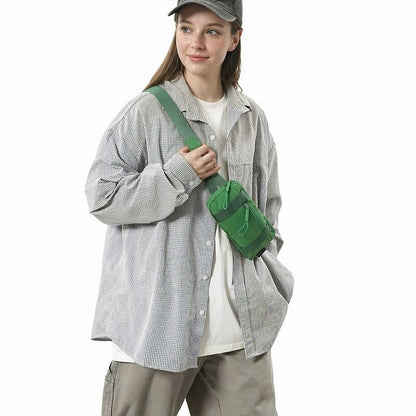 Model carrying the green mini belt bag as a shoulder crossbody accessory.