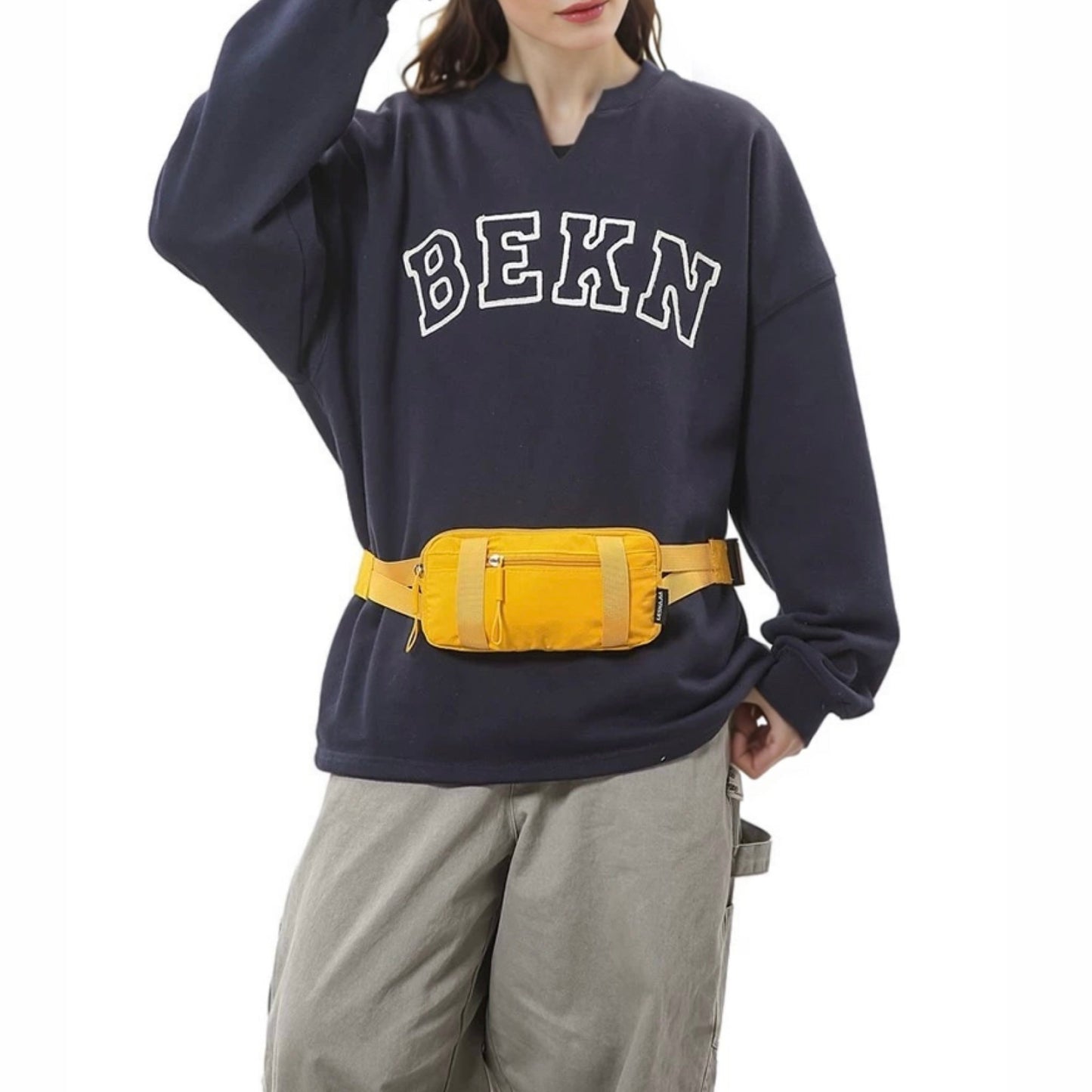 Model wearing a bright yellow mini nylon belt bag at the waist.
