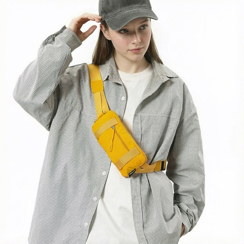 Model styling the yellow mini belt bag as a crossbody chest pack.