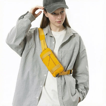 Model styling the yellow mini belt bag as a crossbody chest pack.