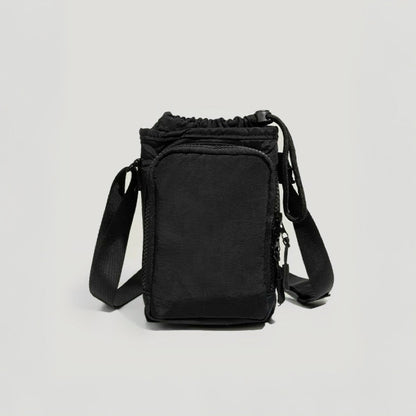 A versatile black water bottle carrier with an adjustable strap, ideal for aesthetic travel photography and short-distance hiking.