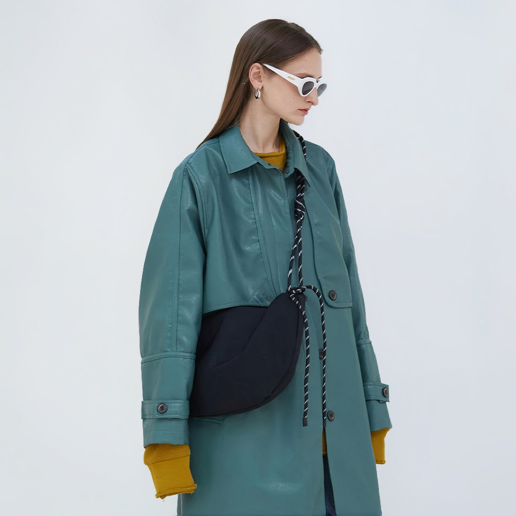 Side view of a black nylon hobo bag worn as an crossbody bag, perfect for daily commute and office chic.
