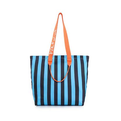 Angled view of Polyester tote bag with bold blue and black vertical stripes, orange shoulder straps, and grab handles.