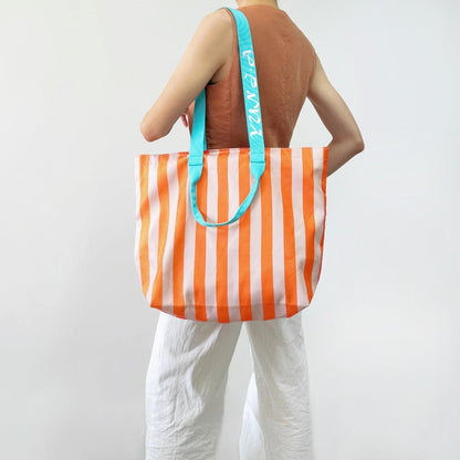 Flat lay of Bold Color Striped Tote Bag in orange, ideal for errands and gifting.