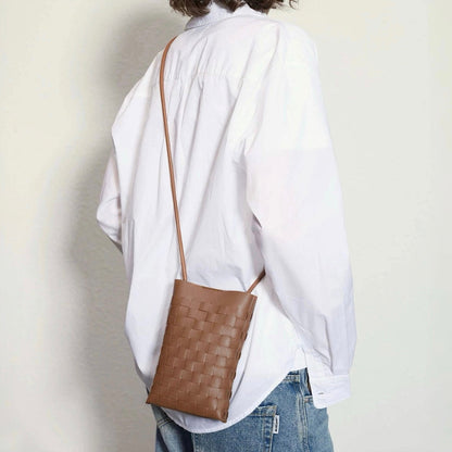 Model carrying a brown Braid Elegance Crossbody Bag as crossbody , ideal for city walks and gifting.
