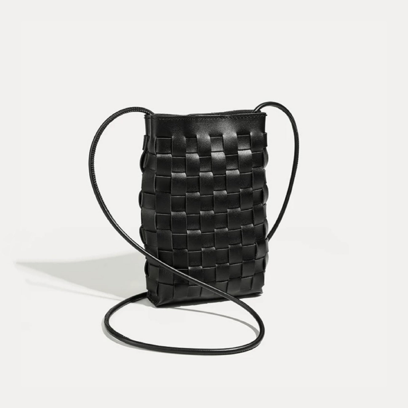 Flat lay of Braid Elegance Crossbody Bag in black, ideal for errands and gifting.