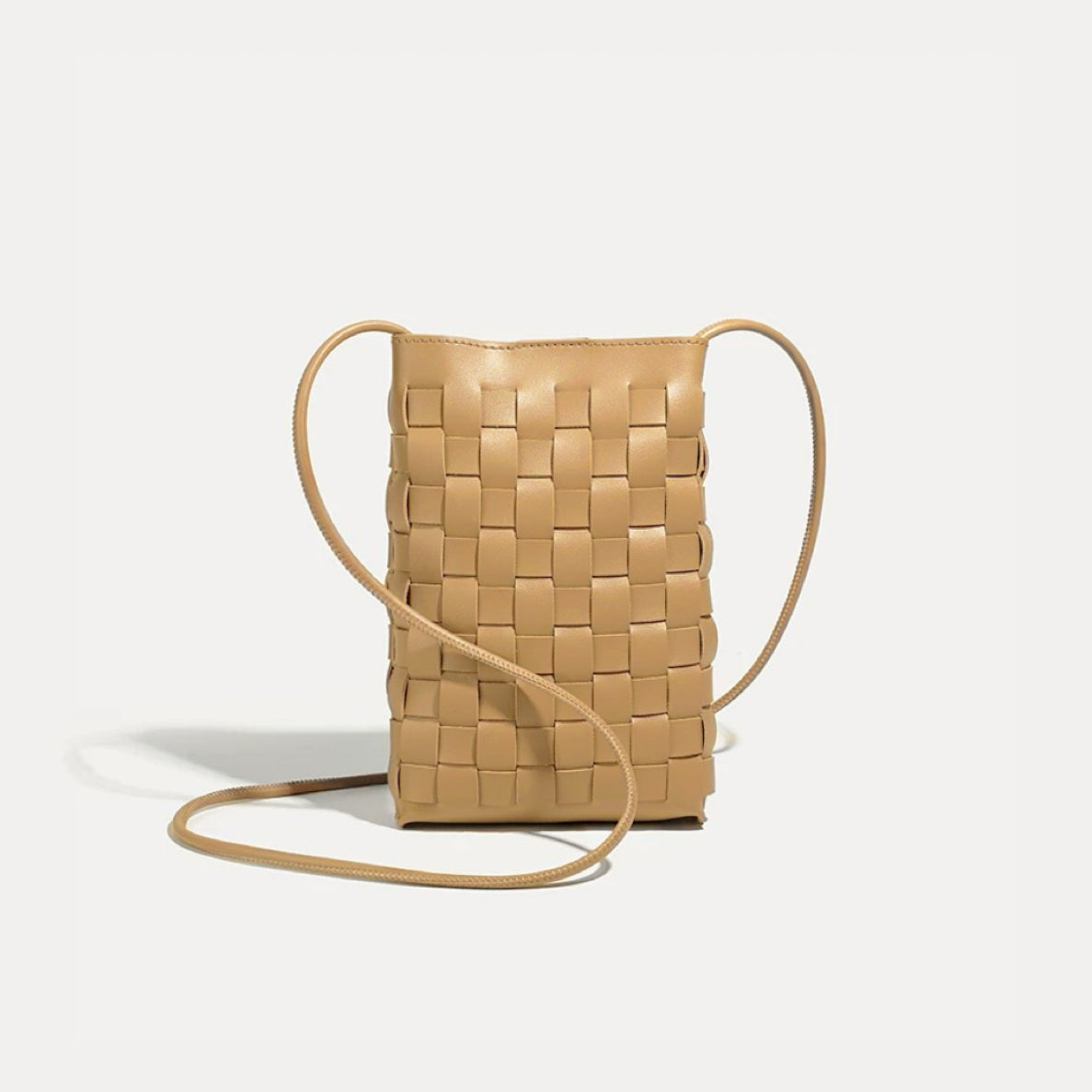 Angled view of Braid Elegance Crossbody Bag in camel, great for everyday carry and travel.