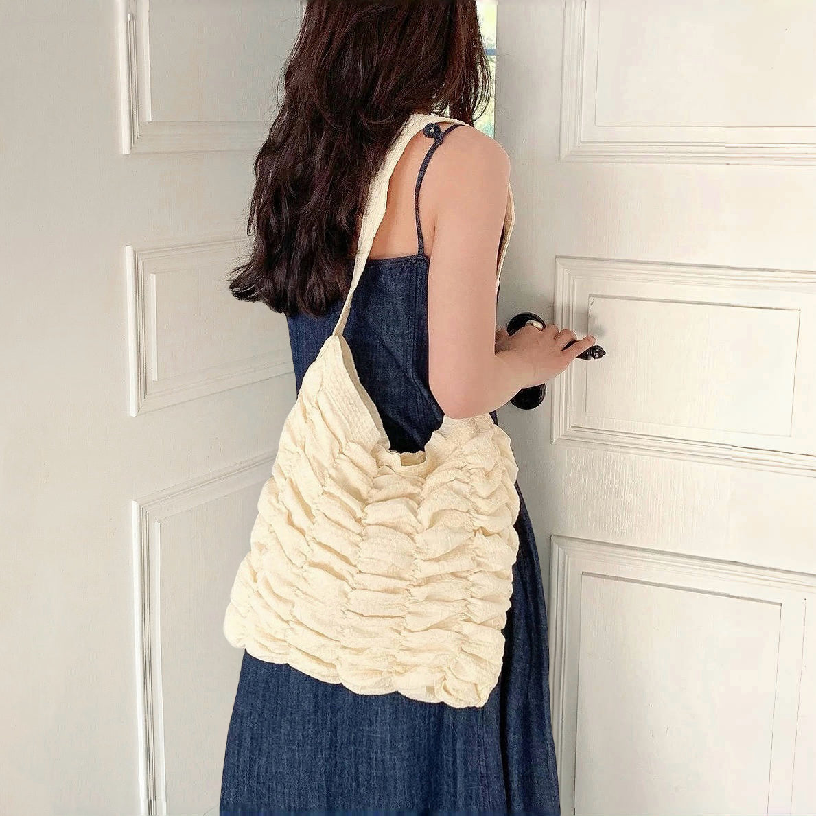Model carrying a white polyester bag on the shoulder, great for daily carry and travel.