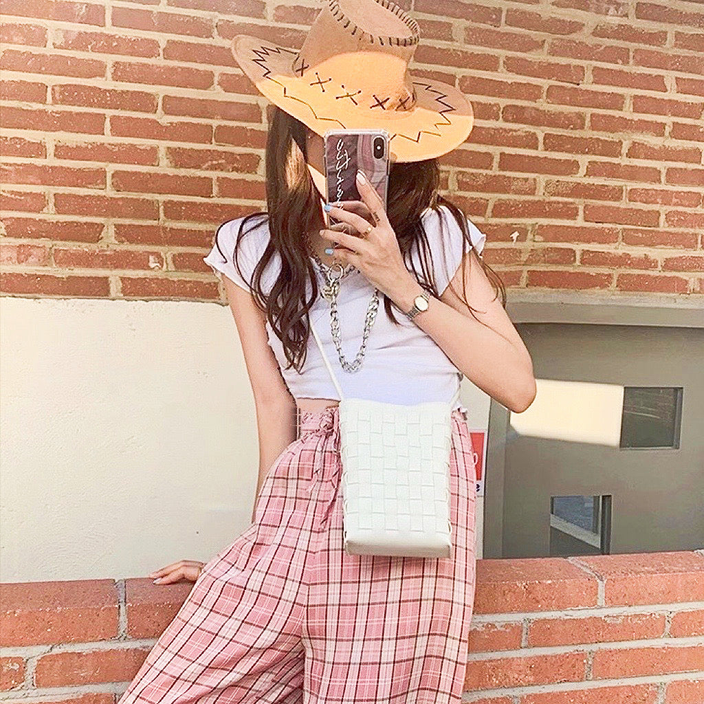 Model carrying a white crossbody bag as crossbody, easy for commuting and weekends.