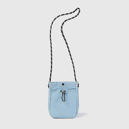 Folded view of a mini crossbody bag in blue, easy for commuting and weekends.