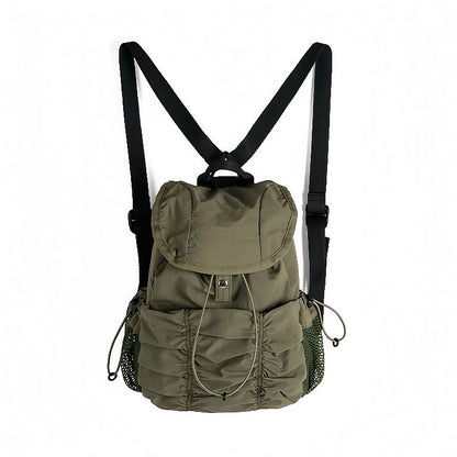 Olive green pleated backpack; durable nylon material suited for Gorpcore style and outdoor urban exploration.