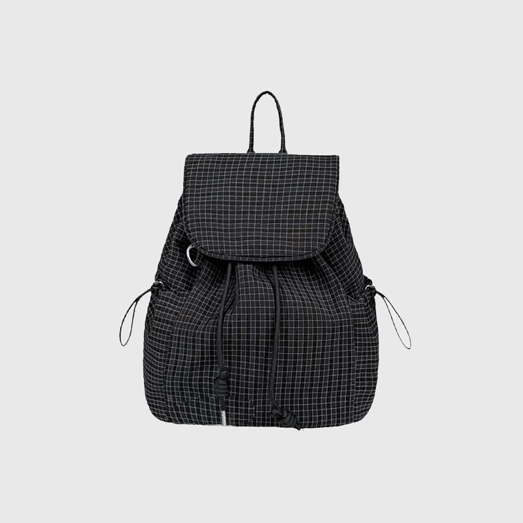 Flat lay of Check Mate Mini Backpack cotton bag in black, great for everyday carry and travel.