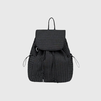 Flat lay of Check Mate Mini Backpack cotton bag in black, great for everyday carry and travel.