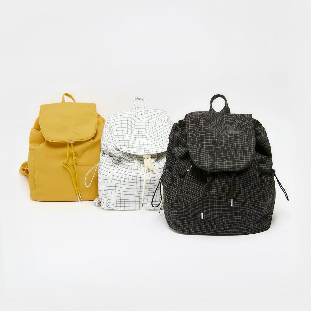 Three Check Mate Mini Backpack shown together, with drawstring and magnetic snap closures.