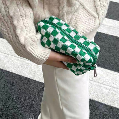 Model styling a bright green checkerboard bag as a clutch; perfect for casual outfit and vibrant street style.