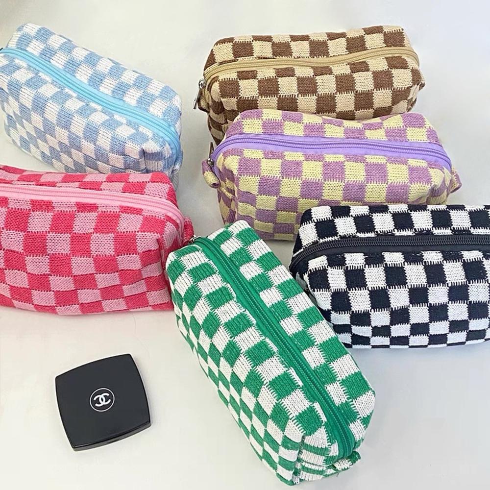 Six vibrant knit checkerboard makeup bags in pink, green, purple, blue, brown, and black; trendy dopamine aesthetic pouches.