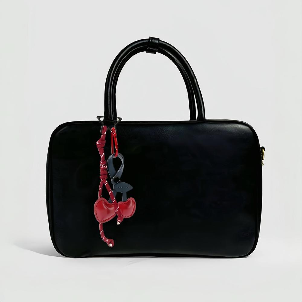 Cherry Bag Charm with rope hanging on a bag, easy for gifting and photo-ready styling.