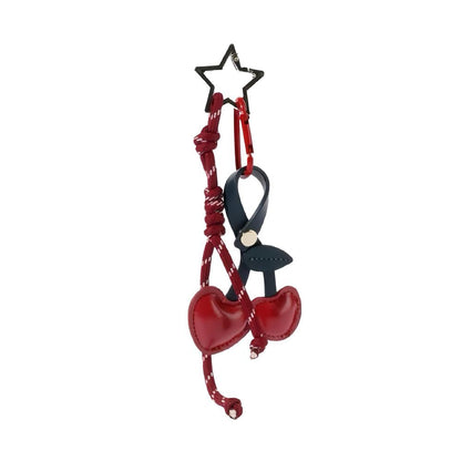 Front view of Red PU leather cherry bag charm with a star keyring and dark blue strap, great for everyday styling.