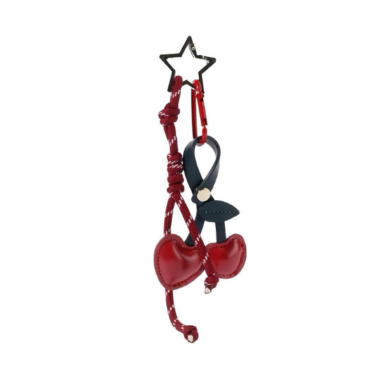 Front view of Red PU leather cherry bag charm with a star keyring and dark blue strap, great for everyday styling.