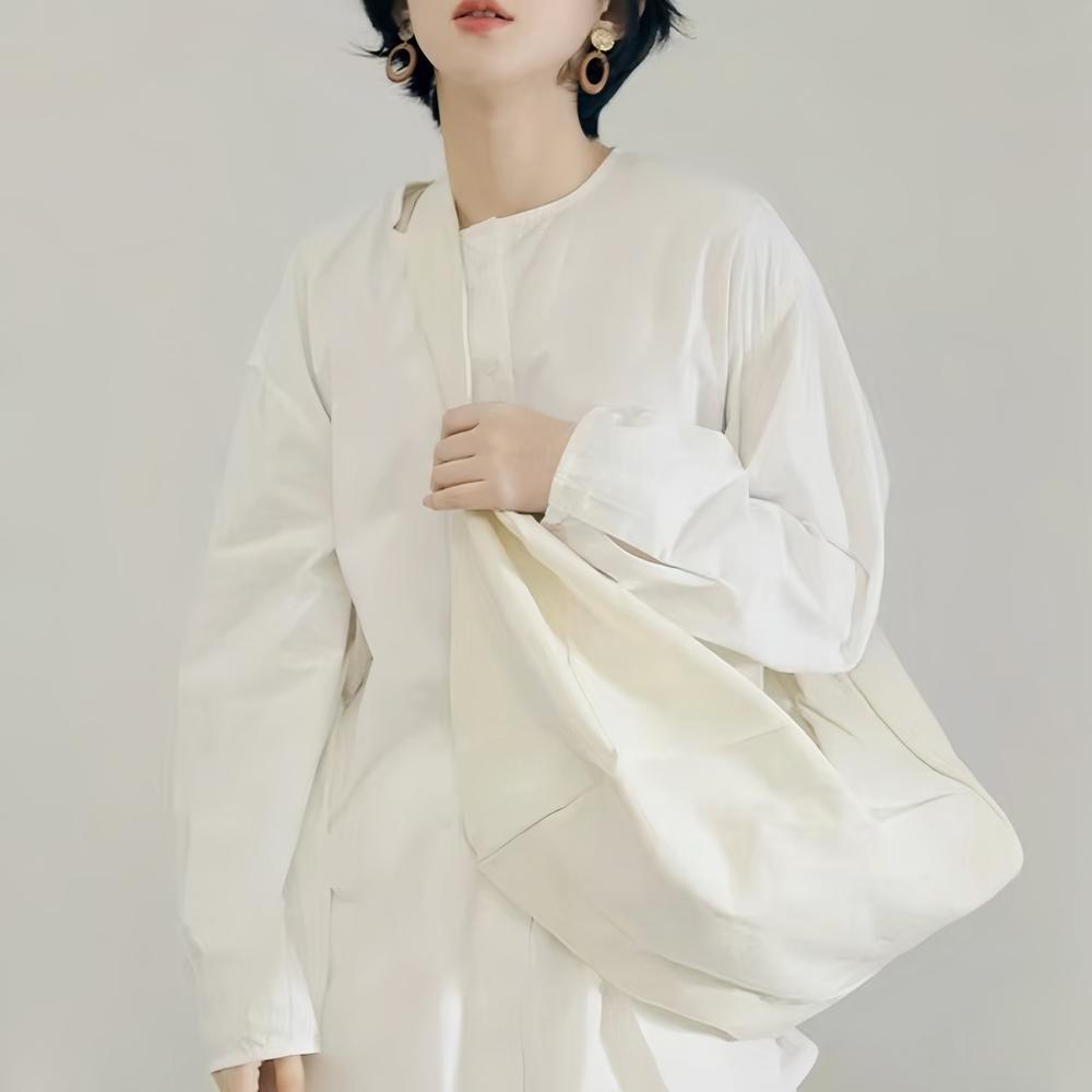 Model carrying a white bag as crossbody, great for daily carry and travel.