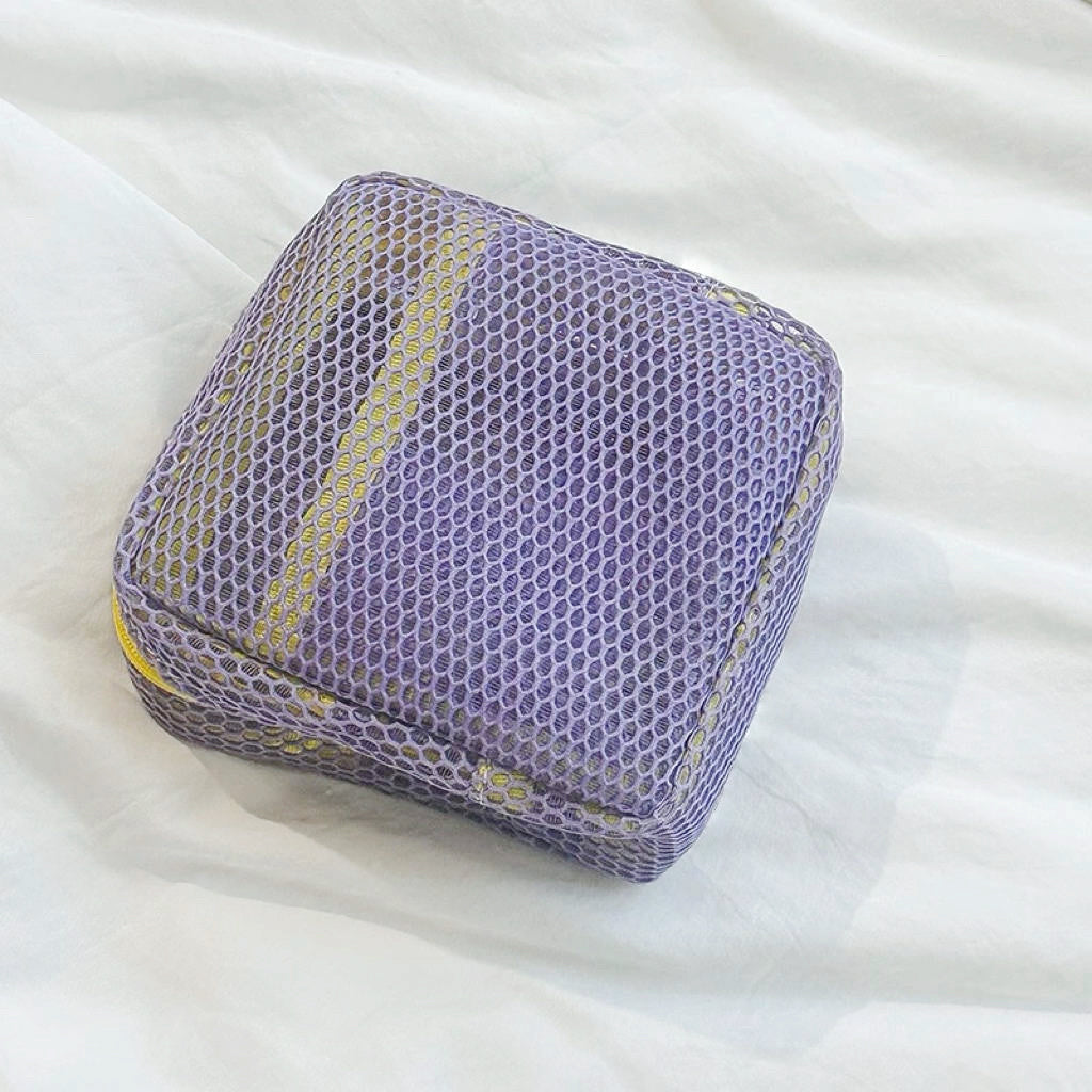 Lilac Chroma mesh pouch with yellow zipper; mesh zip organizer for skincare and small accessories.
