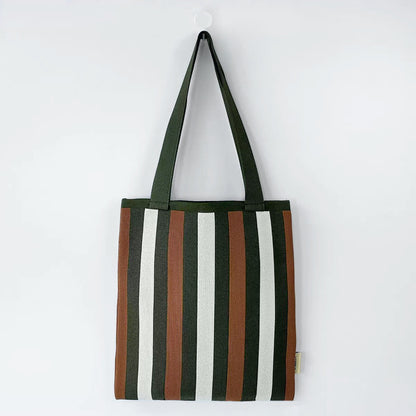 Close-up of Polyester knitted tote bag with vertical stripes in dark green, brown, and white.