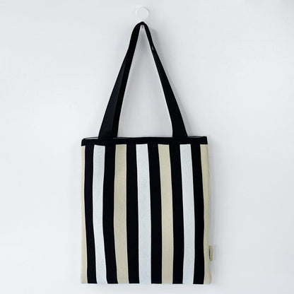 Front view of Chromatic Stripe Knitted Bag in black and white, ideal for errands and gifting.
