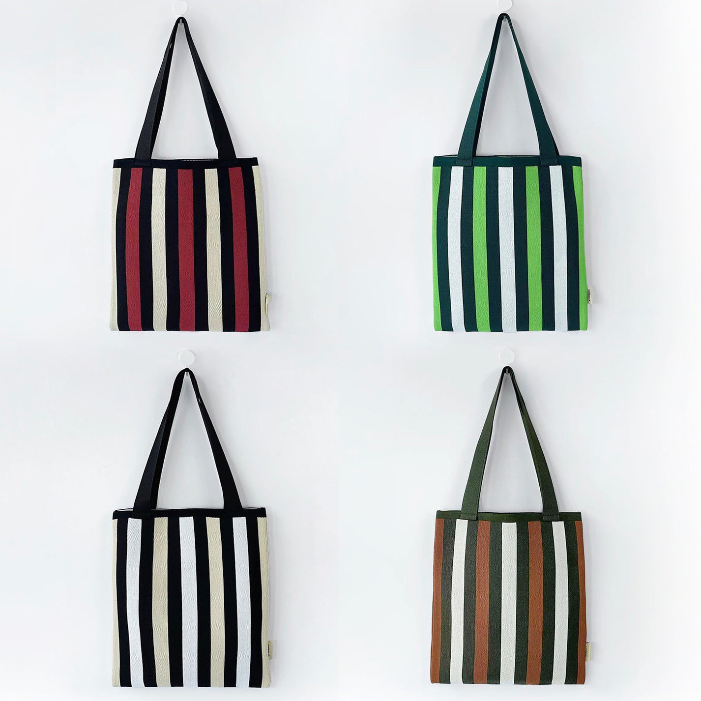 Front view of Four polyester striped knitted bags: red, green, black, and brown, each with shoulder straps polyester.