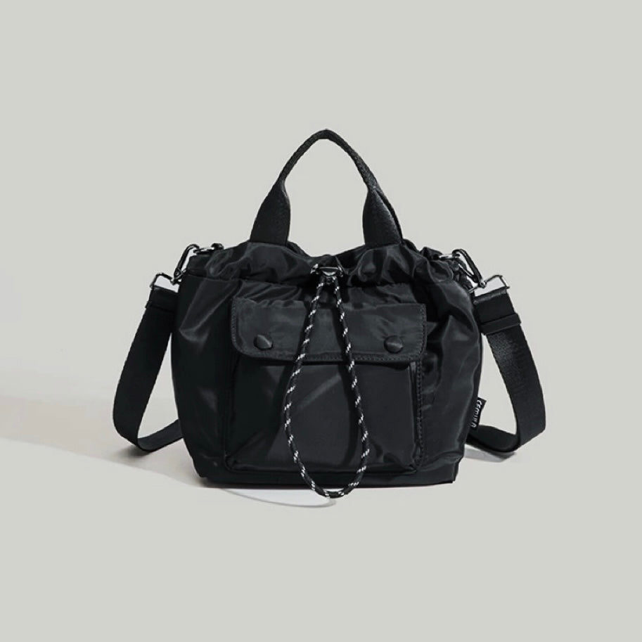 Classic black cube utility crossbody bag with a sleek minimalist profile.