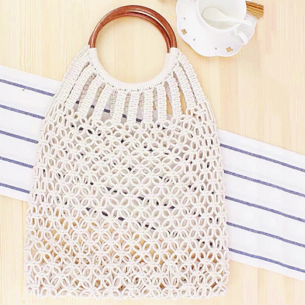 Flat lay of Crochet Handbag With Wooden Ring in white, great for everyday carry and travel.