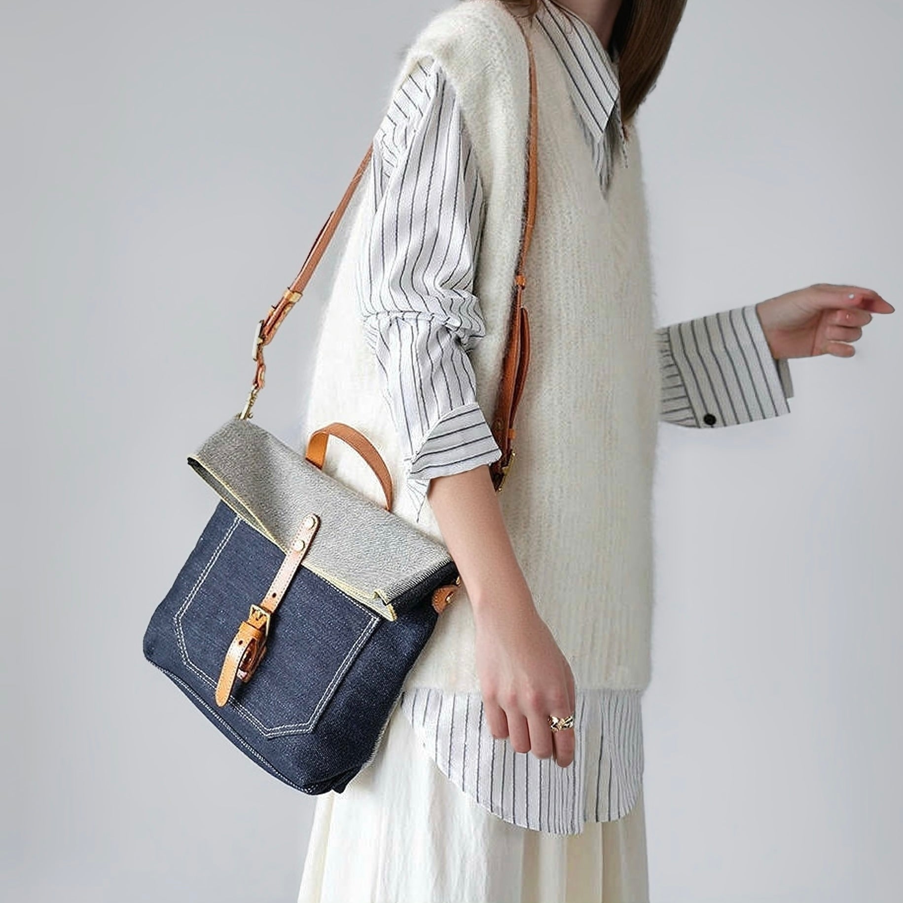 Model carrying a Denim Trimmed Messenger Bag on her shoulder, easy for commuting and weekends.