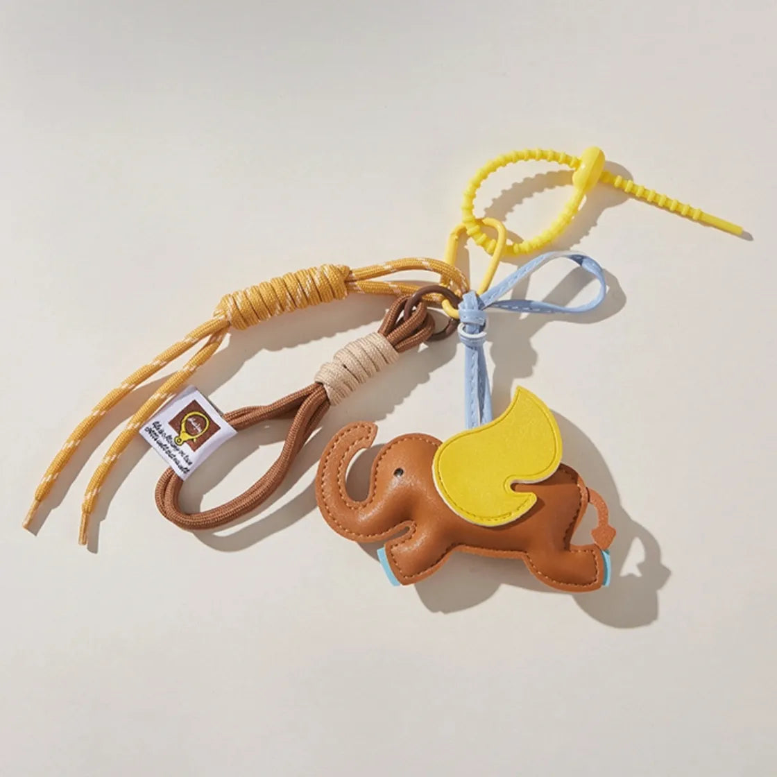 Flat lay of Dumbo Bag Charm, easy to attach to bags and phones.