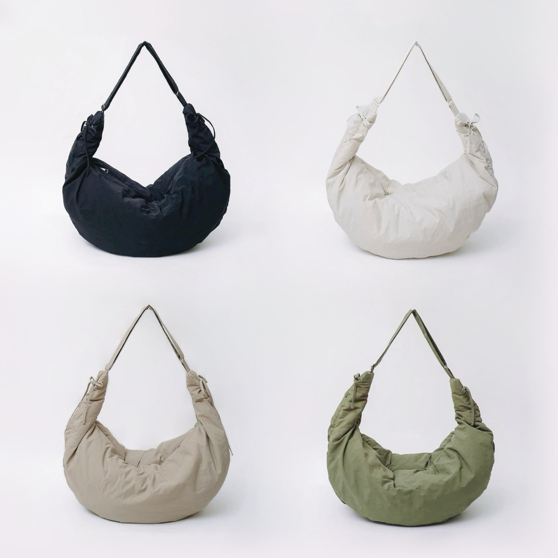 Group shot of the duvet crescent bag in black, off-white, khaki, and olive green.