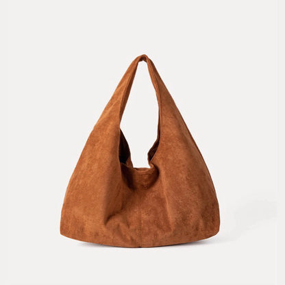 Soft-touch warm tan ease suede hobo bag with a foldable design.