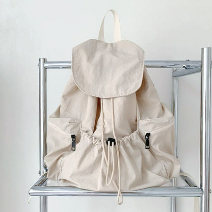 Front view of beige ultralight backpack; soft neutral tone suited for minimalist fashion and summer organization.