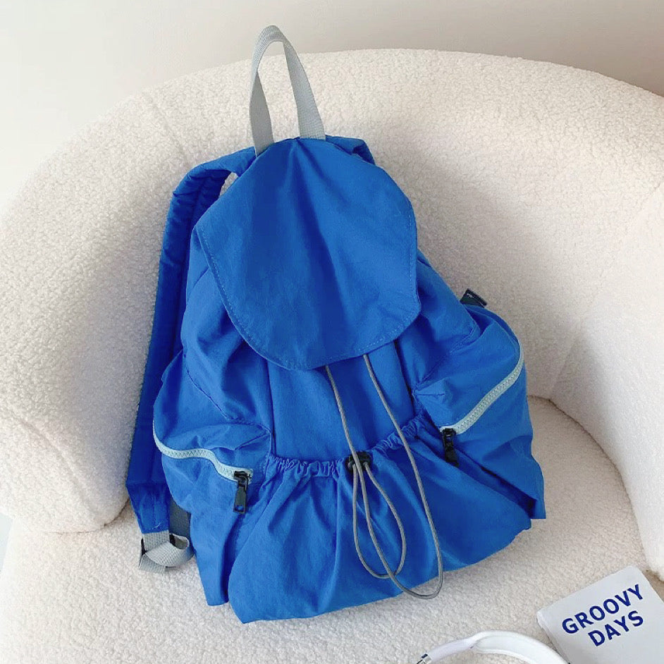 Bright blue ultralight nylon backpack with drawstring closure; lightweight design for vibrant urban mobility.