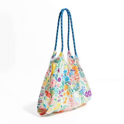 Polyester Floral Bloom Tote Bag with colorful flower print and blue rope straps.