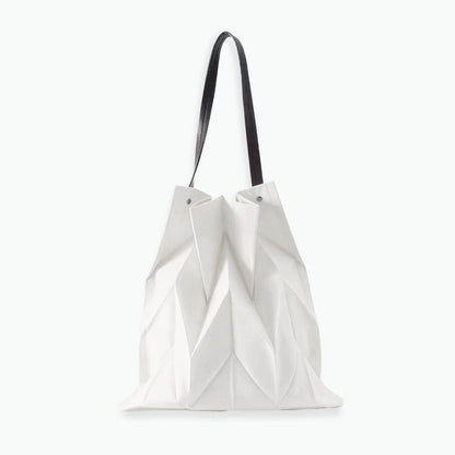 Front view of white pleated shopper bag; sleek geometric texture ideal for pairing with summer dresses and light outfits.