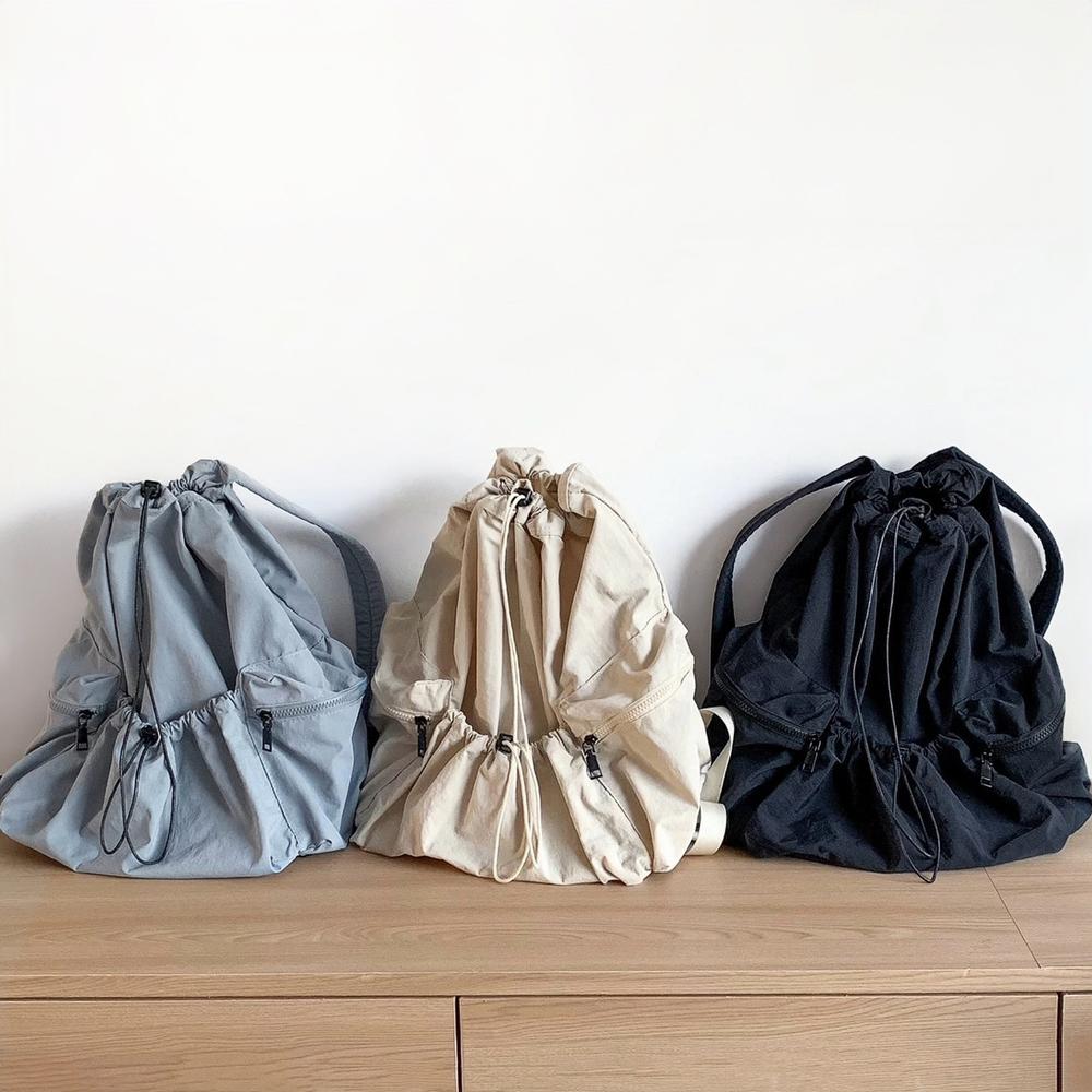 A collection of foldable ultralight waterproof backpacks in blue, beige and black.