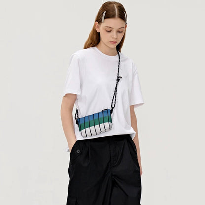 Model wearing the FREEIN designer striped bag in a high-waisted crossbody style for a trendy urban look.