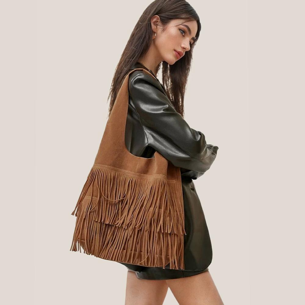 Model wearing the tan fringe suede hobo bag as a casual shoulder bag.