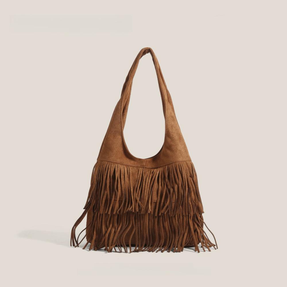 Tan vegan suede hobo bag with bohemian fringe detailing and a soft slouchy silhouette.