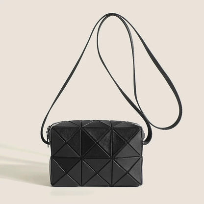 Close-up of Black GeoChic PU leather crossbody bag with geometric quilted design and adjustable strap.