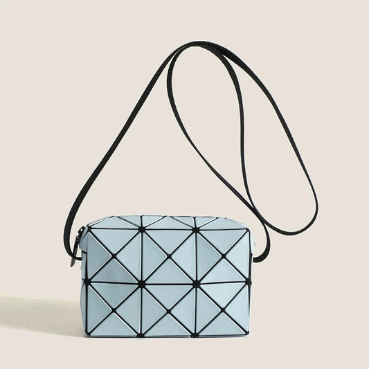 Front view of Light blue GeoChic crossbody bag with geometric PU leather design and black adjustable strap,.